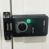 安裝於白色門上的 MILRE 黑色數位電子鎖（Digital Door Lock）主機特寫，中央旋鈕亮起綠燈，右下角附有 YSDL 品牌標籤